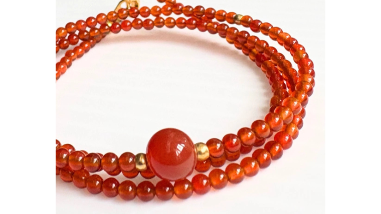 3連に連ねた赤めのうと中央の丸玉が特徴の天然石ネックレス。落ち着いた赤色が大人の女性に似合う上品なデザインです。