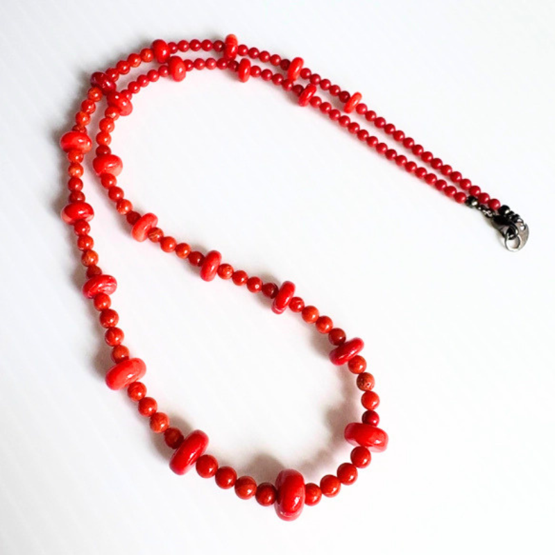 Red coral gradient necklace with graduated beads in various sizes