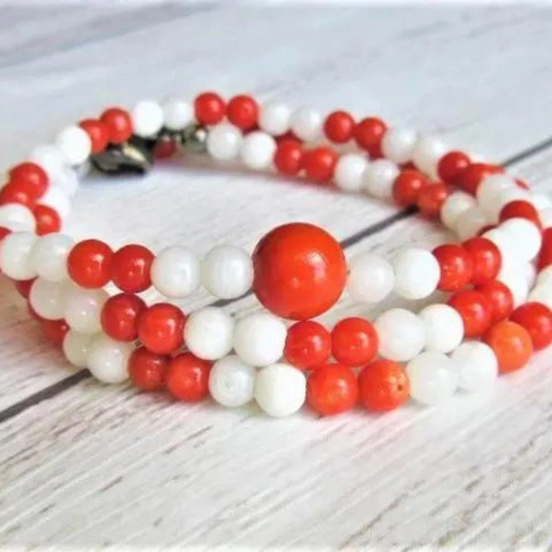 Red coral and shell pearl beads alternating necklace, flat lay